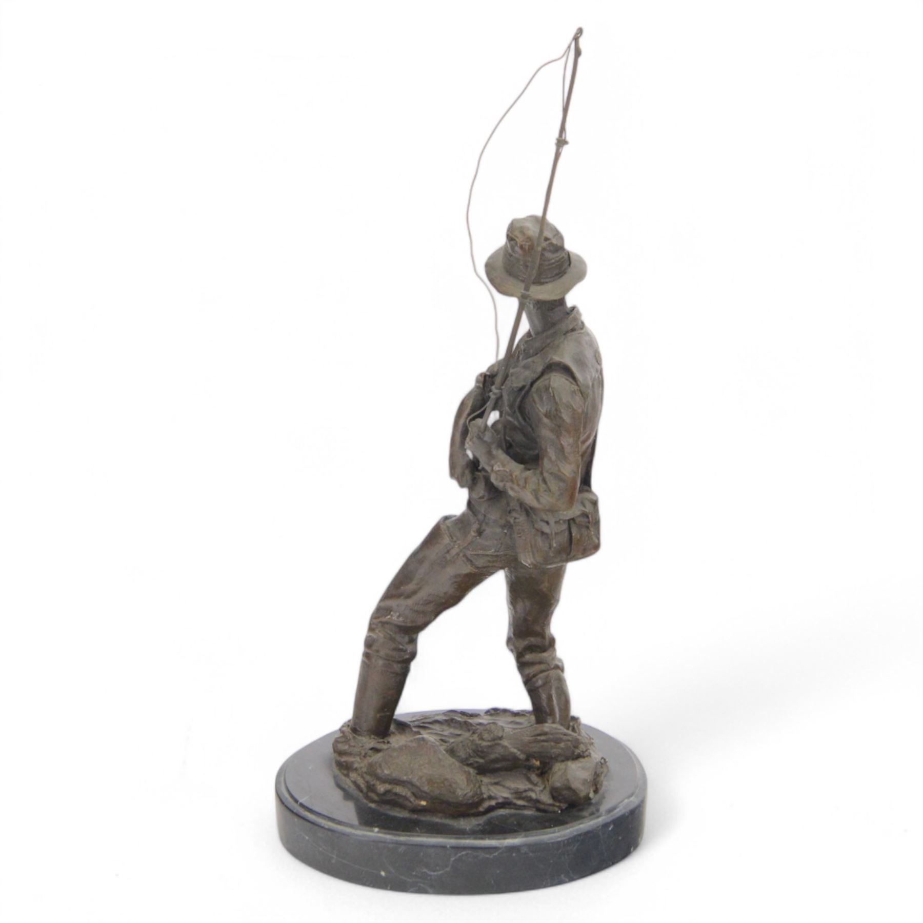 Bronzed figure of a fly fisherman, signed Milo, upon an oval marble base, H42.5cm