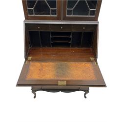 Early 20th century mahogany bureau bookcase, the projecting cornice over blind fret work frieze and two astragal glazed doors, sloped hinged lid enclosing fitted interior and leather inset, four graduating drawers, shaped apron and cabriole feet