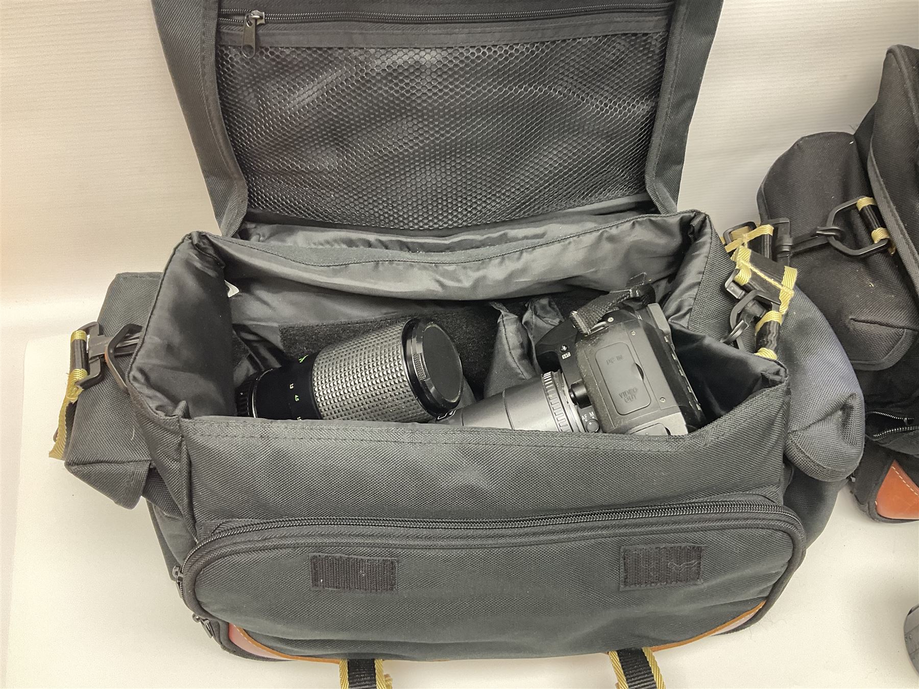 Four camera bodies, to include, Ricoh KR-10 serial no. 38826, Pentax MZ-M serial no. 4185969 with 'SMC Pentax- M 1:3.5 28mm' lens, Canon EOS500 serial no. 080927, with 'Sigma Zoom 100-300mm 1:4.5-6.7 DL'  lens etc, with other camera lenses and equipment 