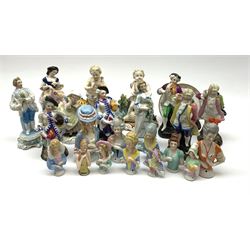 A collection of Continental porcelain pin cushion dolls, Sitzendorf figure of a girl together with other porcelain figures