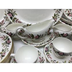 Wedgwood Hathaway Rose pattern tea and dinner wares, comprising twelve saucers, sixteen teacups, twenty tea plates, jug, sucrier, thirteen shallow bowls, sauce boat and saucer, two lidded tureens, larger jug, ten dinner plates, nine smaller plates and two large oval serving dishes
