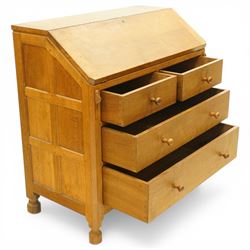 Mouseman - oak adzed bureau, fall front with carved mouse lopers, with fitted interior, above two short over two long drawers, by the workshop of Robert Thompson of Kilburn
