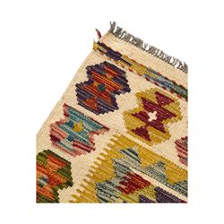 Chobi Kilim flatweave rug, cream ground with a multicoloured geometric diamond field, framed by a bold border of repeating stylised motifs, finished with braided corner tassels