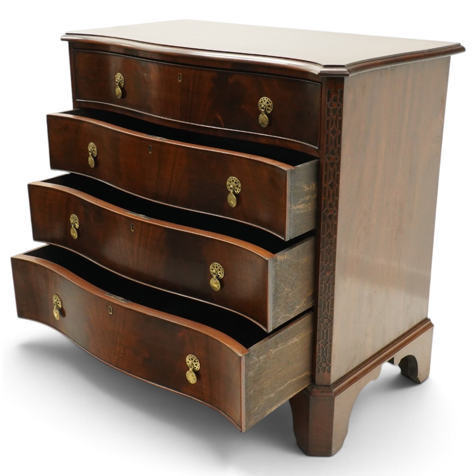 Quality Georgian design mahogany serpentine secretaire chest, the shaped top with moulded edge, fitted with cock-beaded secretaire drawer with button-release fall-front enclosing fitted interior, over three graduating drawers with brass drop handles on pierced circular plates, the canted uprights carved with blind-fret strapwork, lower moulded edge on shaped bracket feet