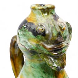 Two early 20th century Italian glazed terracotta wine flasks, one of twin handled form, applied with shells and insects, the other formed as a male figure, H24cm (2)