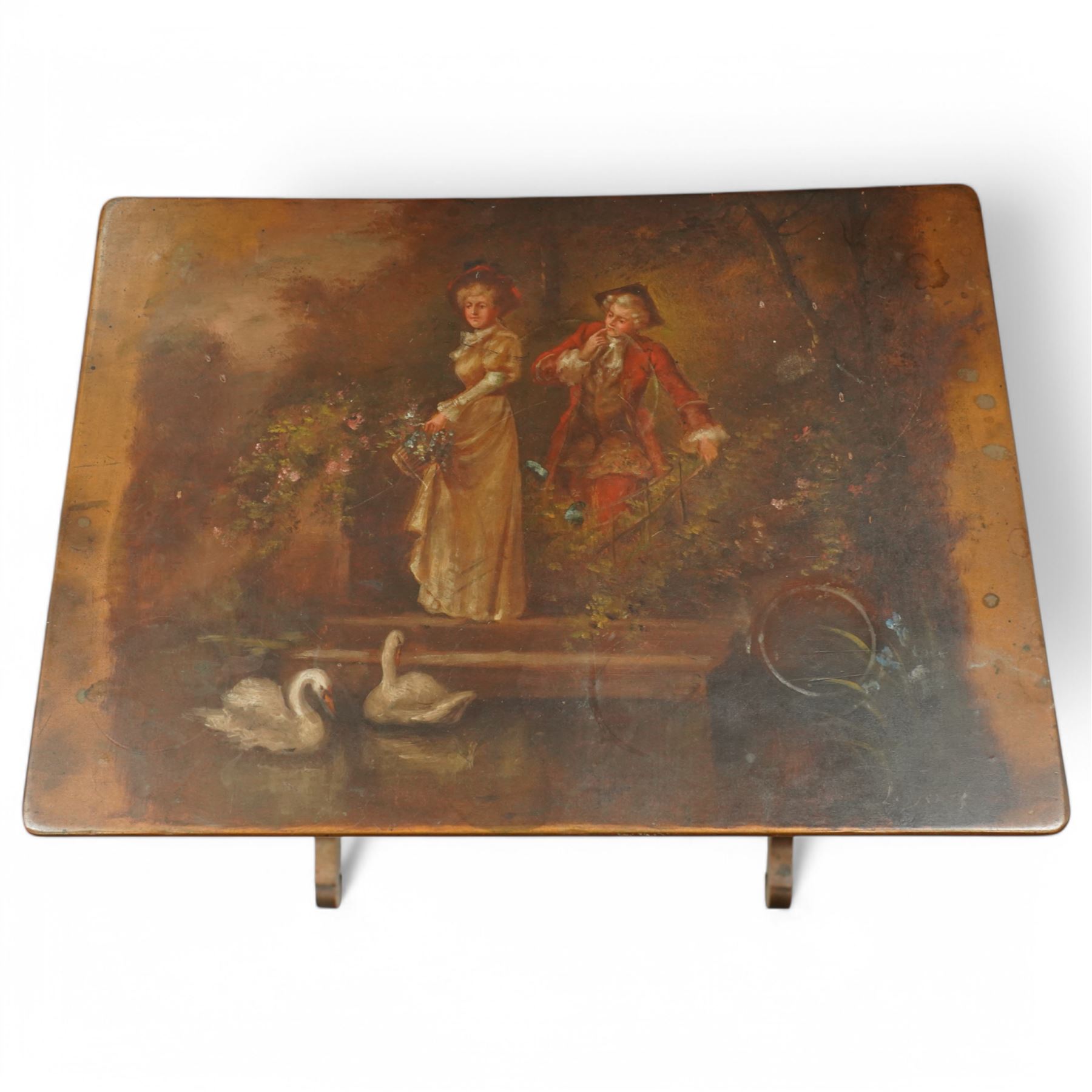 French 19th century painted nest of tables, the largest depicting a romantic scene of courting lovers by a swan lake, indistinctly signed L Desi**, the smaller tables painted with rural landscapes, the painted rectangular tops raised on ring turned end supports united by stretcher