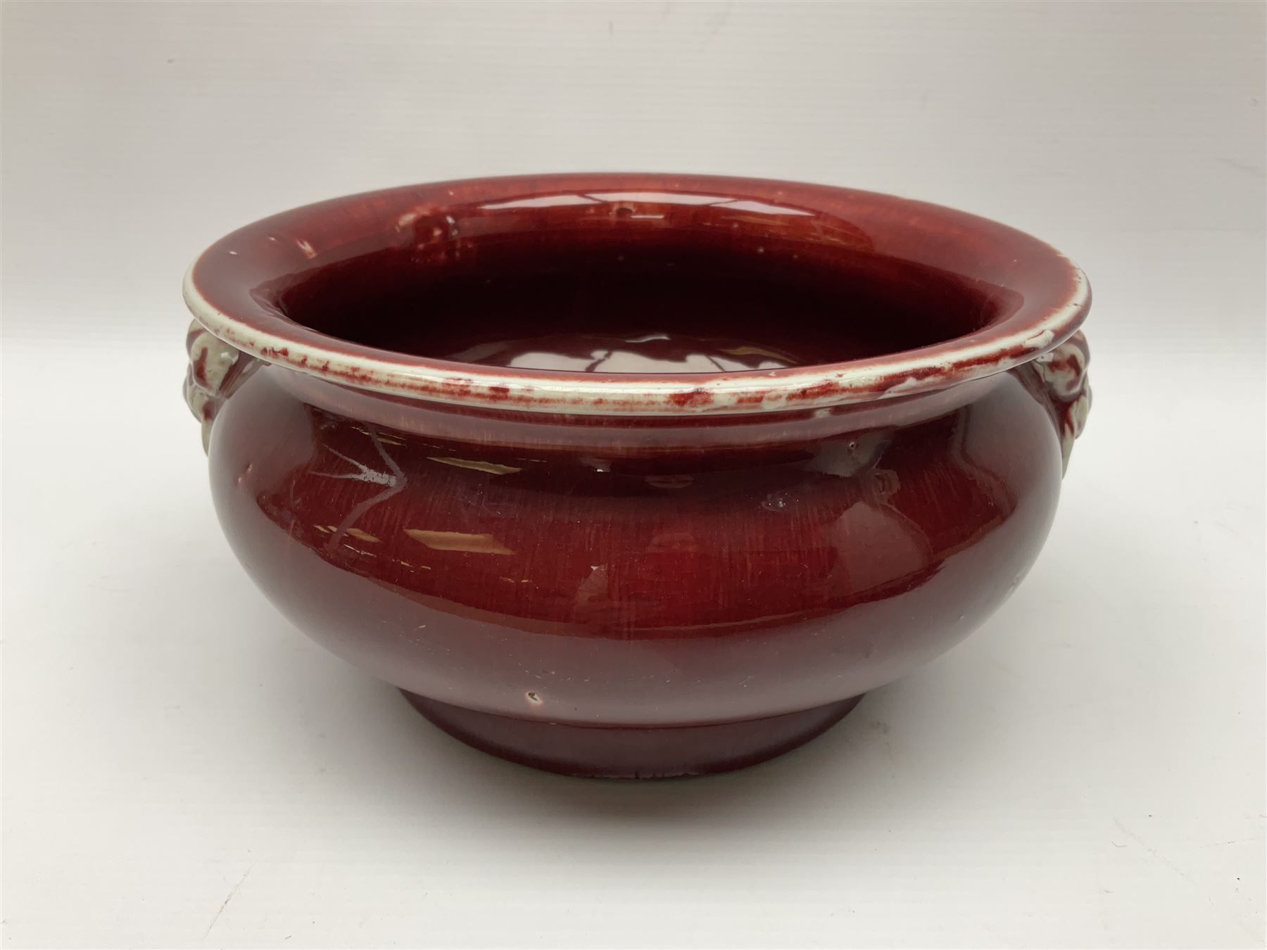 Qing Chinese Sang De Boeuf incense burner, Qing Dynasty, of bombe form with applied lion-mask handles, H11cm
