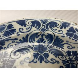 Early 18th century Delft marriage plate, of circular form with dished centre, the centre inscribed and dated 'Thomas and Elizabeth Kockerill Bridlington Key 1715' within a crowned C scroll cartouche, flanked by demi-griffins, above a putto head and tassels, within a wide foliate border, D34cm
