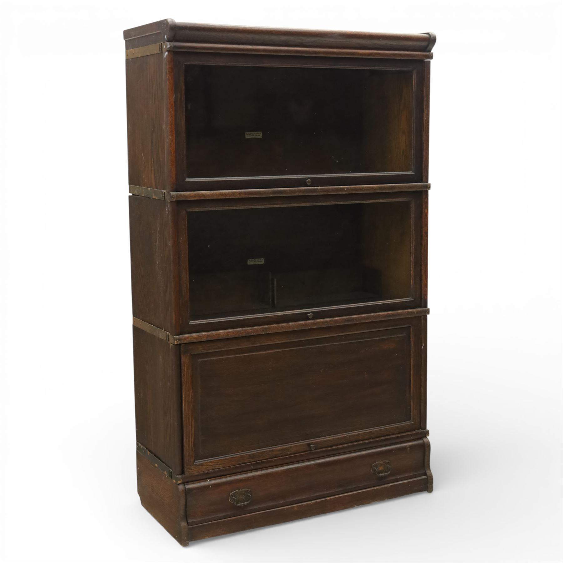 Globe Wernicke - early 20th century three sectional stacking library bookcase, two glazed sections above a panelled section, on a plinth base with inbuilt drawer