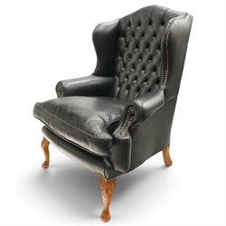 Pair of quality Georgian design wingback club armchairs, the high arched back with wings over rolled arms, upholstered in back-buttoned black leather with loose seat cushion, raised on foliate carved cabriole supports
