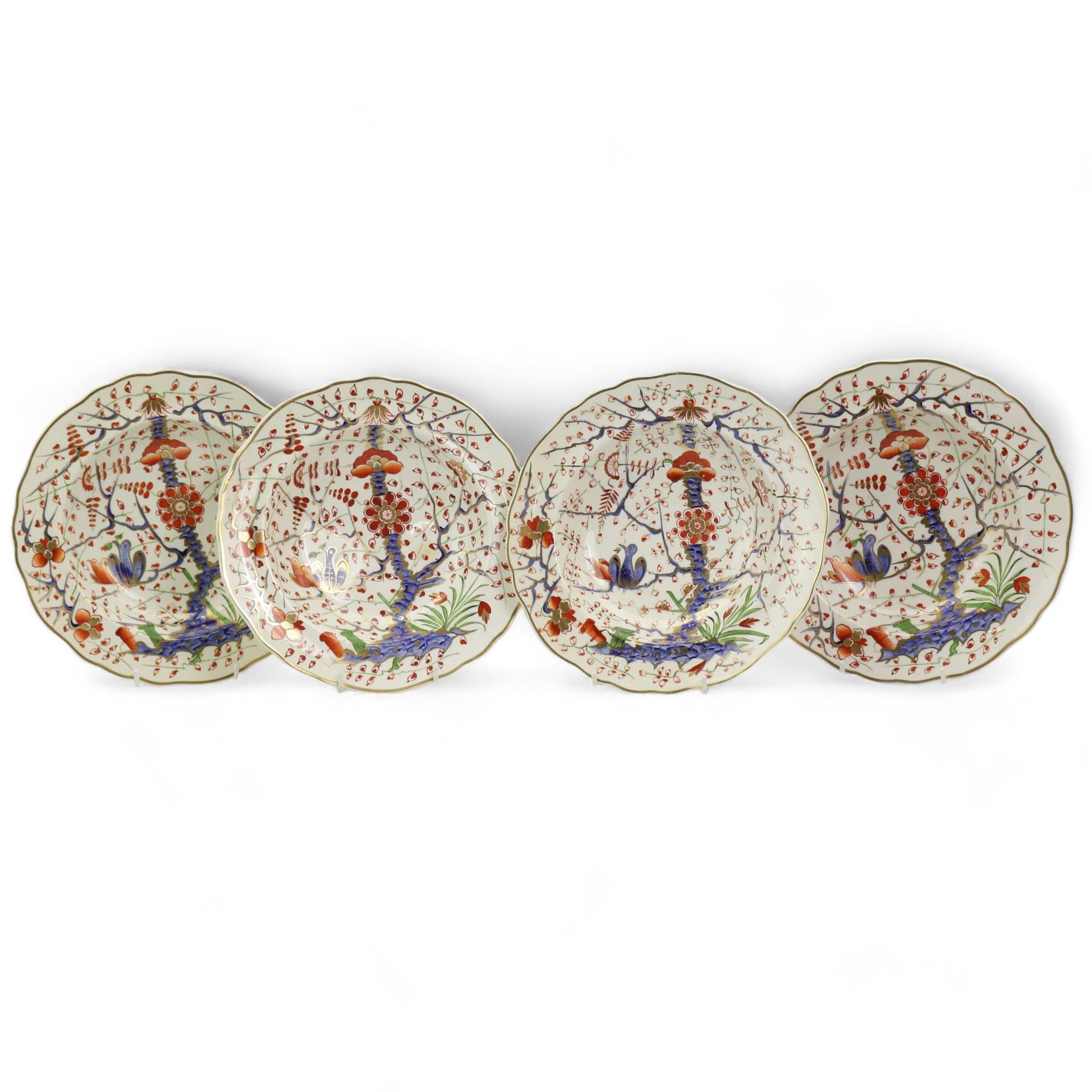 Set of four early 19th century Derby porcelain bowls decorated in the 'Tree of Life' pattern, in the imari palette, within shaped gilt borders, D26cm (4)