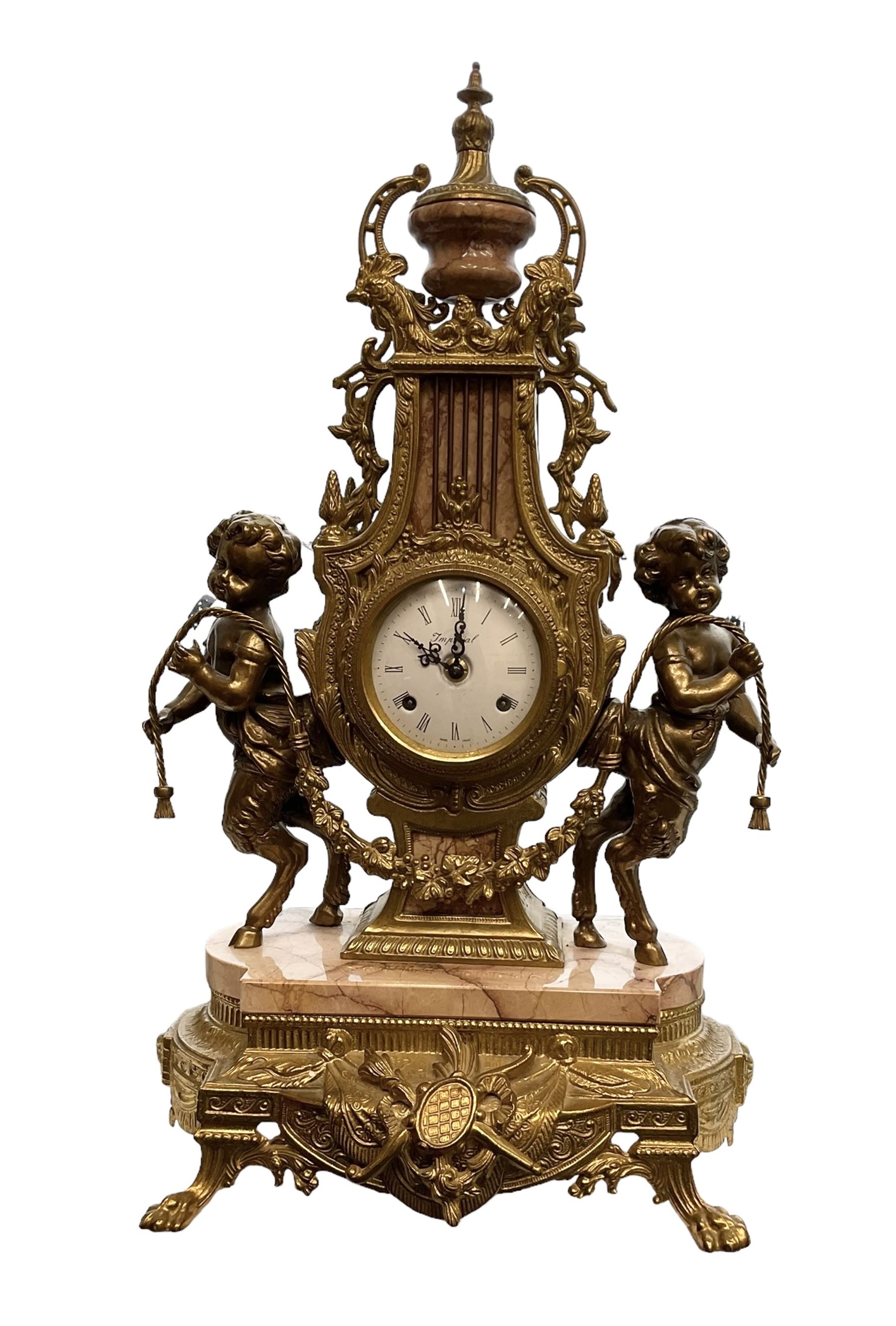 Imperial - 20th century continental 8-day brass and marble mantle clock, with an enamel dial, Roman numerals and pierced gilt hands, twin train striking movement sounding the hours and half hours on two bells, with a floating balance escapement.  With key.