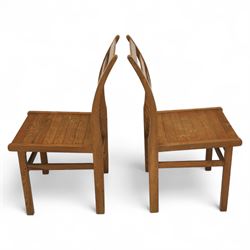 Treske of Thirsk - solid oak refectory dining suite, rectangular top with chamfered edge over trestle base united by a central stretcher, together with six matching slat back dining chairs, including two carvers, with panelled seats and square legs united by stretchers (H 87cm, W 62cm, D 57cm)