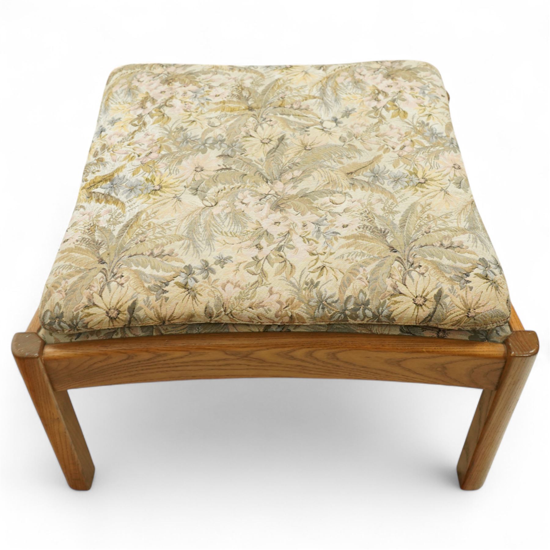 Ercol - golden elm 'Saville' armchair and matching footstool, elm frames with curved back supports and slatted sides, removable cushions upholstered in floral tapestry fabric, footstool (H 39cm, W 59cm)