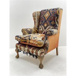 Late 20th century beech framed wingback armchair, sprung seat and back upholstered in kilim cover, acanthus carved cabriole supports with ball and claw feet