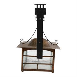 20th century, Arts and Crafts style copper porch lantern, of rectangular form, with cast iron scrolling wall fittings