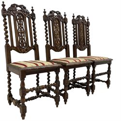 Set of six Victorian Carolean Revival carved oak dining chairs, back pierced and carved with scrolling foliate vines flanked by spiral turned uprights, seat upholstered in striped floral fabric, on barley-twist supports