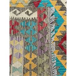 Anatolian Kilim cream ground rug, decorated with repeating diamond motifs in red, blue, yellow, and green, bordered by narrow bands of stylised geometric patterns in contrasting shades