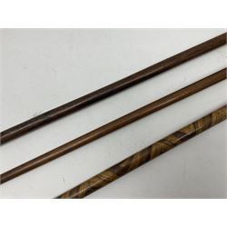 Three early 20th century walking sticks, to include a smoking pipe walking stick, the cane opening to reveal a concealed pipe, and a wooden walking cane, the metal cover with inscription 'bell metal and wood of York Minster, Burnt May 20 1840, and a turned wooden walking stick, with marquetry checkerboard pommel, tallest L90cm