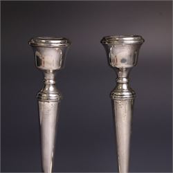 Pair of late 20th century silver candlesticks, each with tapering stem and upon circular beaded weigthed foot, hallmarked A T Cannon Ltd, Birmingham 1970, H21cm