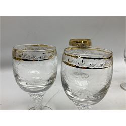 Set of twelve Moser style wine glasses, the bowls with etched floral bodies and gold banded rim with foliate decoration raised upon stem of twisted form, H14cm