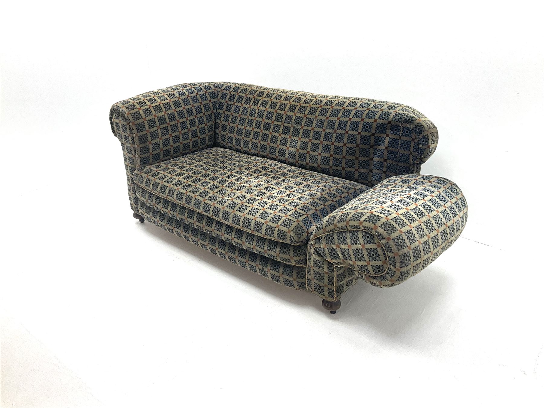 Early 20th century two seater drop arm sofa, upholstered in geometric pattern, turned supports and castors 