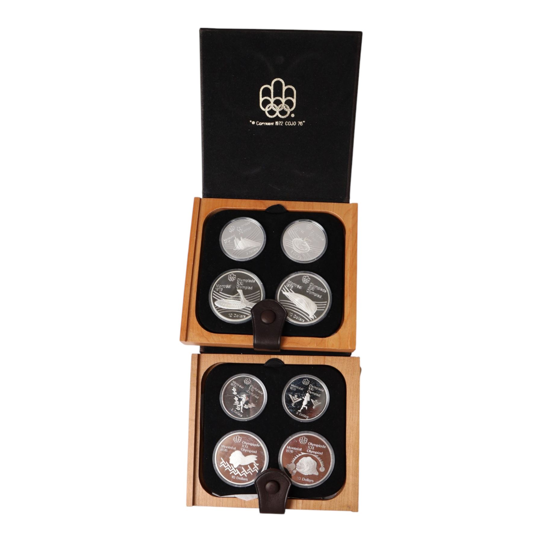 Seven Royal Canadian Mint 1976 'Montreal Olympics' silver proof four coin sets, each containing two five dollar and two ten dollar coins, each cased and boxed with certificates
