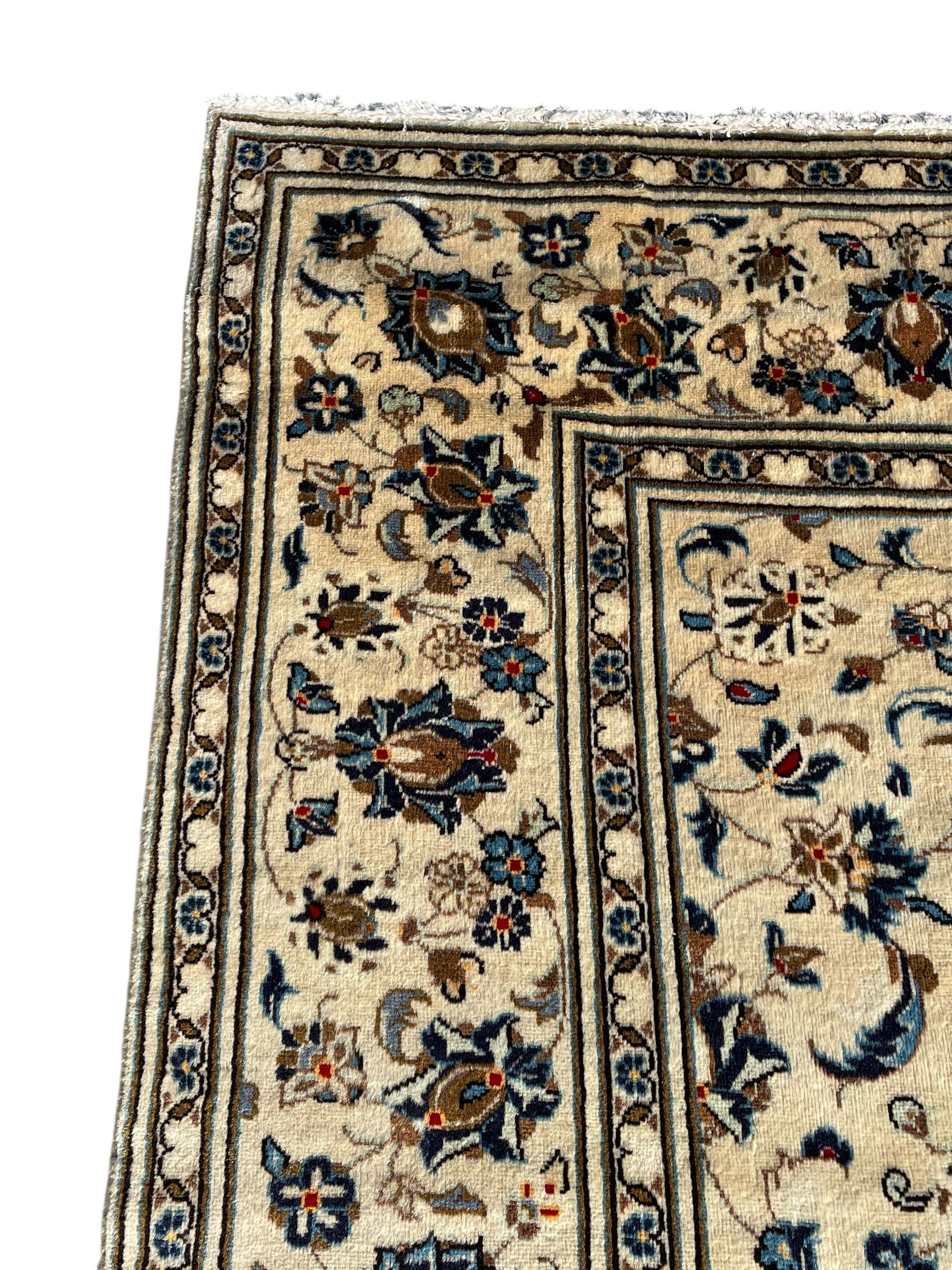 Persian Nain ivory ground rug, the field decorated with trailing leafy branches and palmettes, matching border within guard stripes