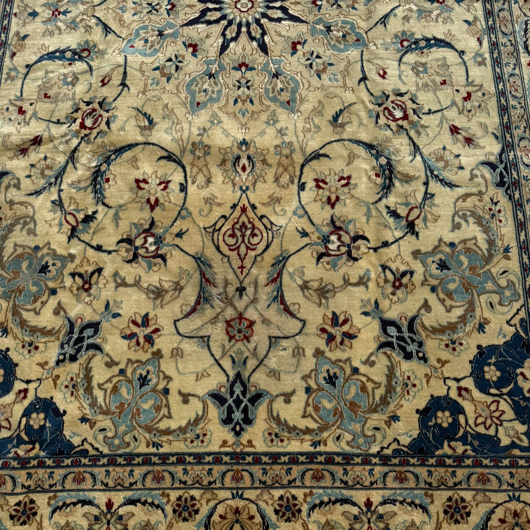 Nain Persian rug, hand knotted with a central medallion surrounded by a symmetrical arrangement of floral motifs, arabesques, curvilinear vines on an ivory background with teal and burgundy colours 