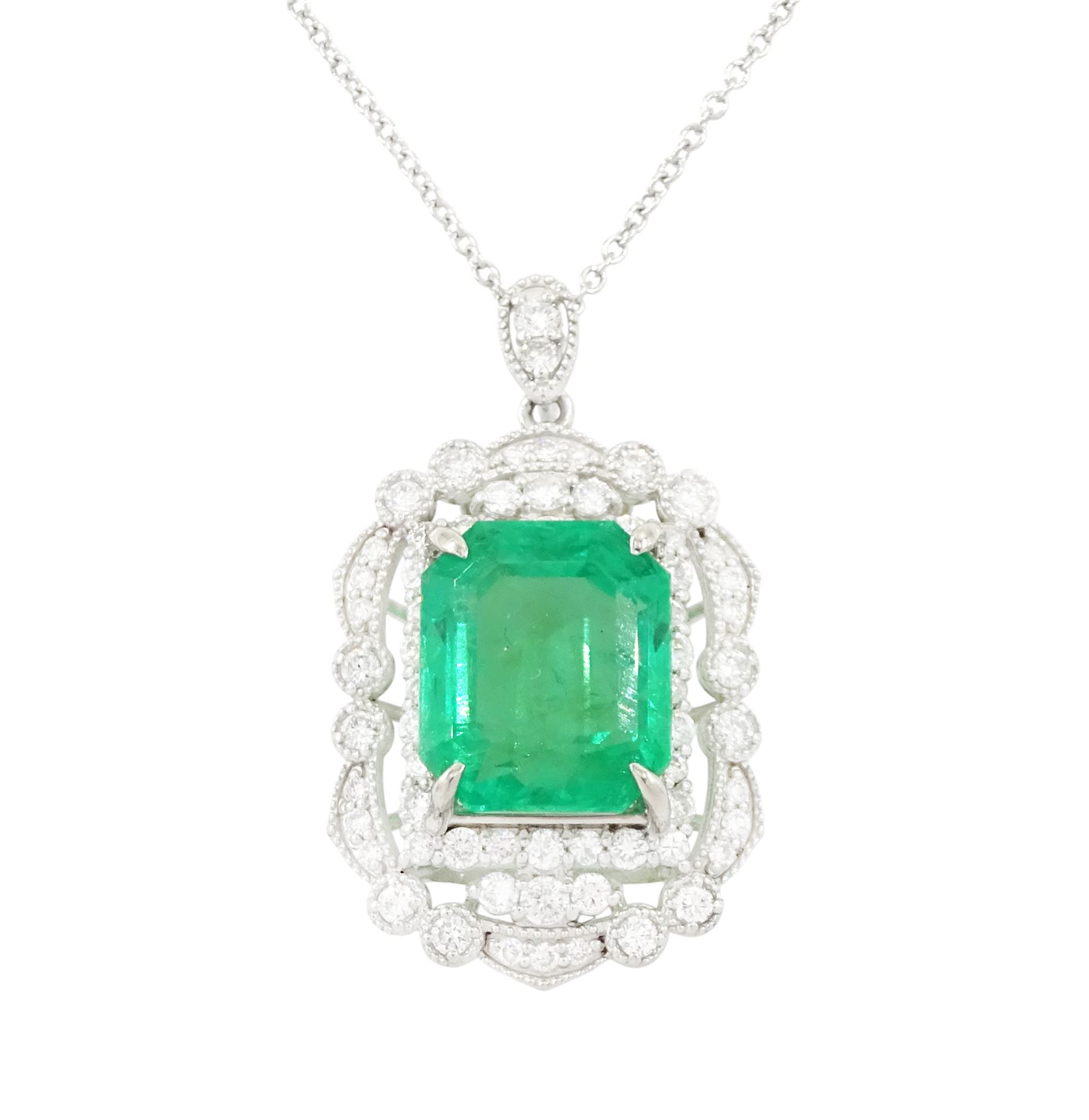 Platinum Colombian emerald and diamond pendant necklace, single octagonal cut emerald of 7.38 carat, surrounded by round cut diamonds in a fancy milgrain pierced design setting, stamped Pt 950, on a trace link chain necklace, total diamond weight 1.14 carat, with GCS certificate