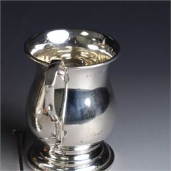 Two late 20th century silver christening mugs, each of plain form with no engraving, together with a small seal top spoon, all hallmarked 