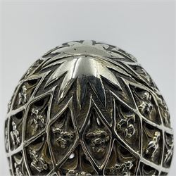Modern silver limited edition Easter egg, no. 70/500, the openwork lattice body decorated with gilded panels of flower heads, opening to reveal a gilt interior, upon silver stand with three scrolling pad feet, each hallmarked St James House Company, London 1979, height including stand 8cm