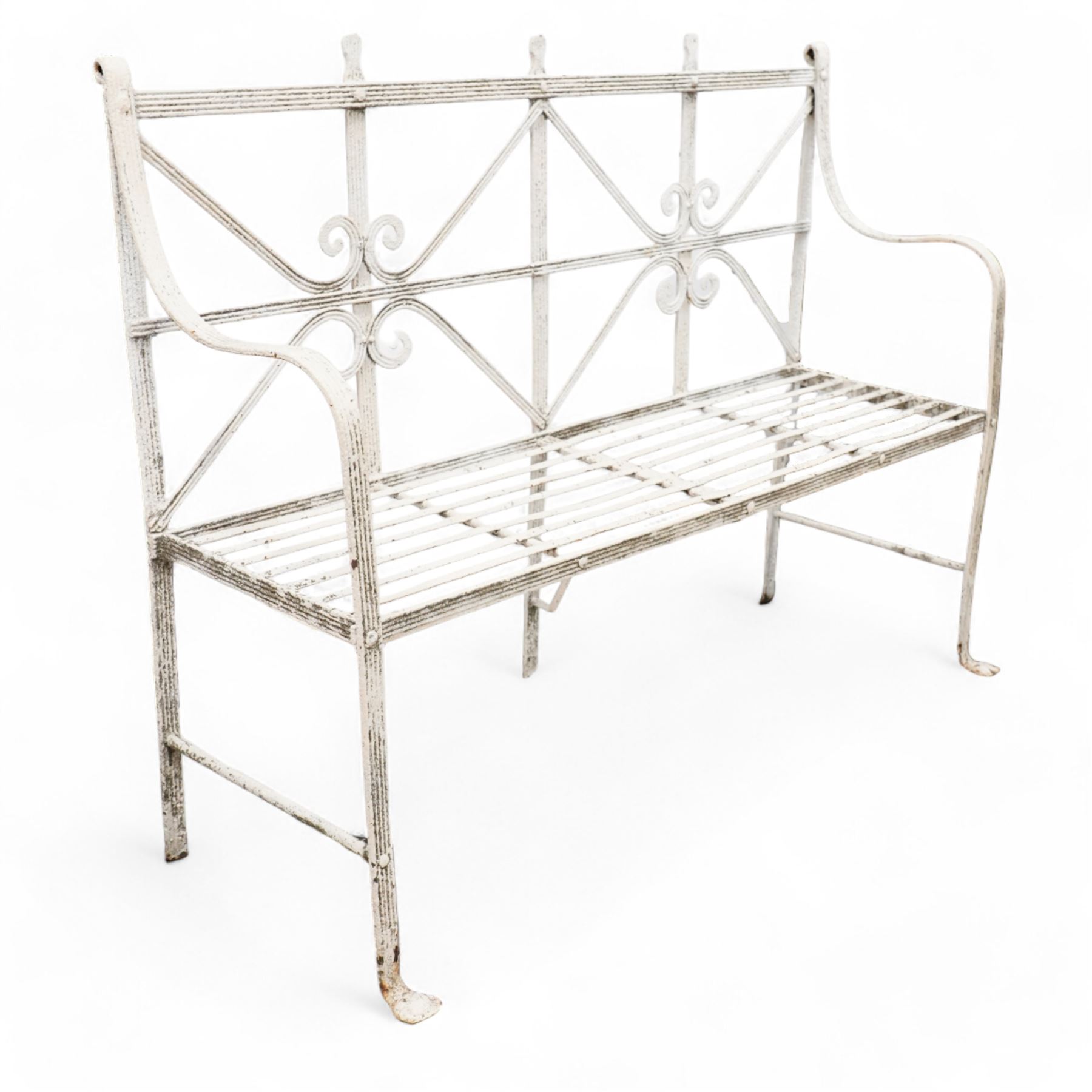 Regency wrought metal strapwork garden bench, moulded strap frame with scrolled back rails and slat seat, shaped end rails terminating to pad feet, in white paint finish.