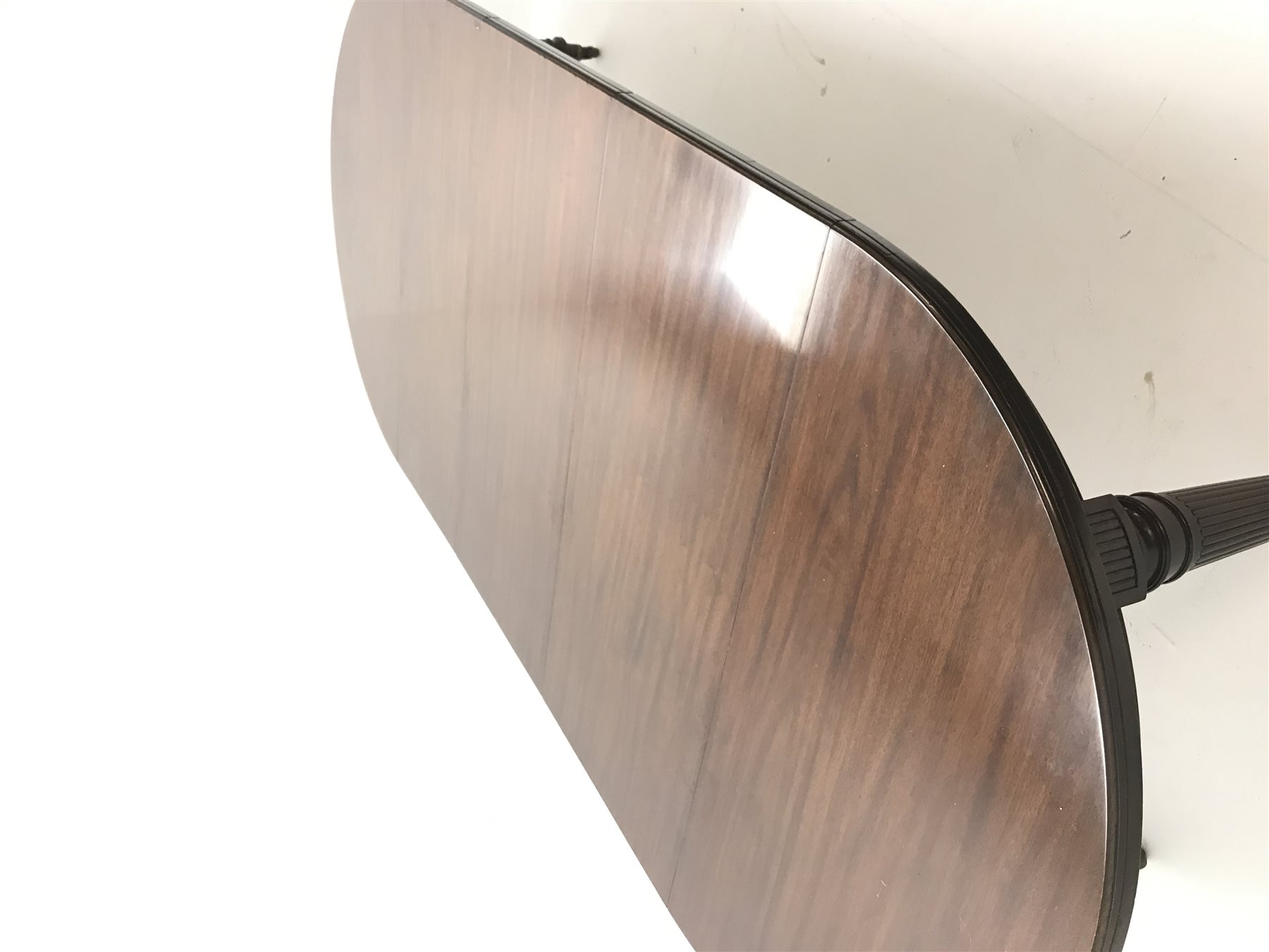 Spillman & Co. London - large Victorian mahogany extending dining table with three additional leaves, on turned and reeded supports with ceramic castors, ivorine label to underneath 'Spillman & Co. St. Martins Lane, London', diameter - 137cm (closed), L302cm (with all leaves)