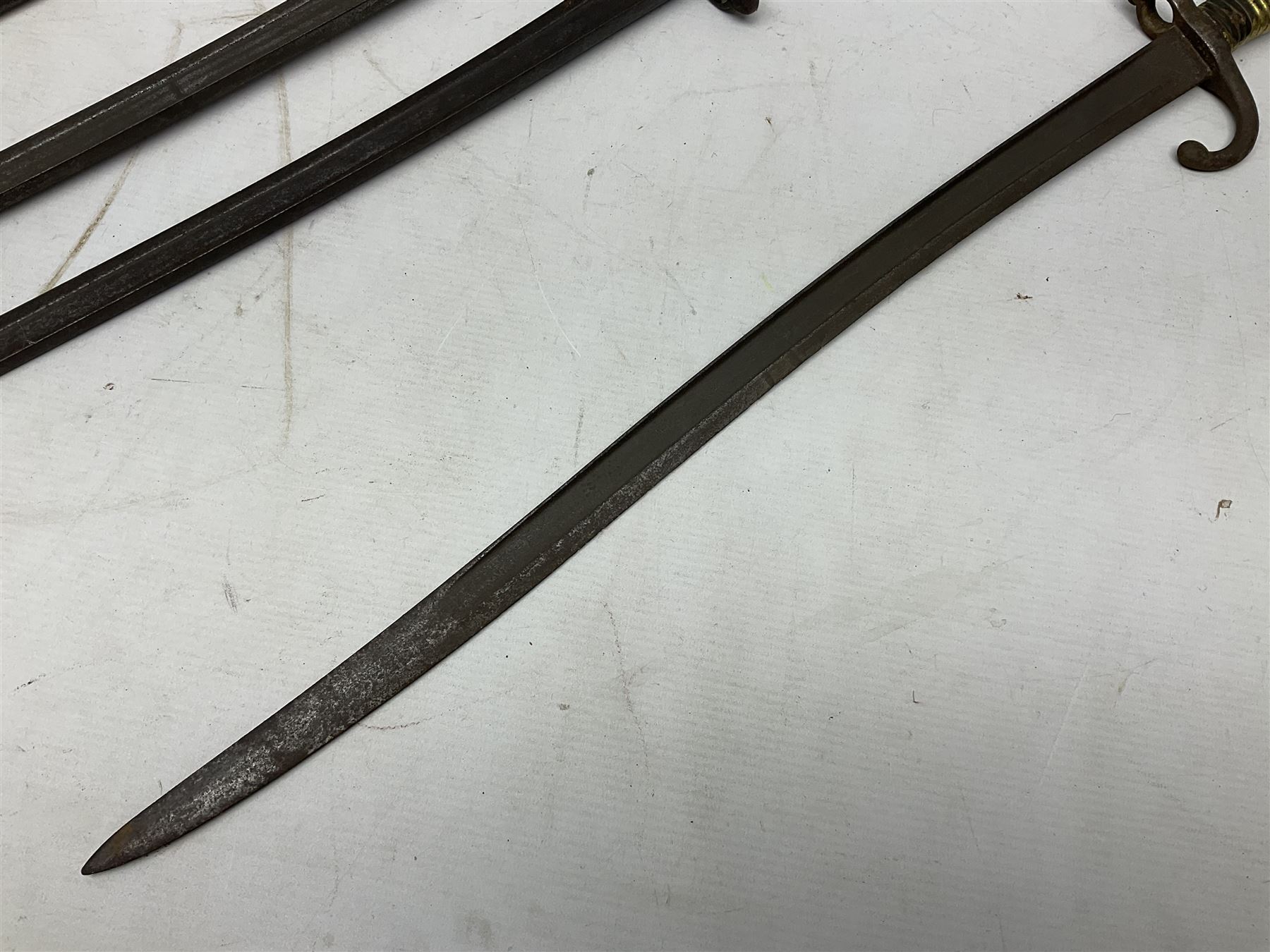 Five 19th century bayonets in relic condition without scabbards comprising British Pattern 1876 socket bayonet with Indian markings; French Model 1874 epee bayonet; and three French Model 1866 sabre bayonets (5)