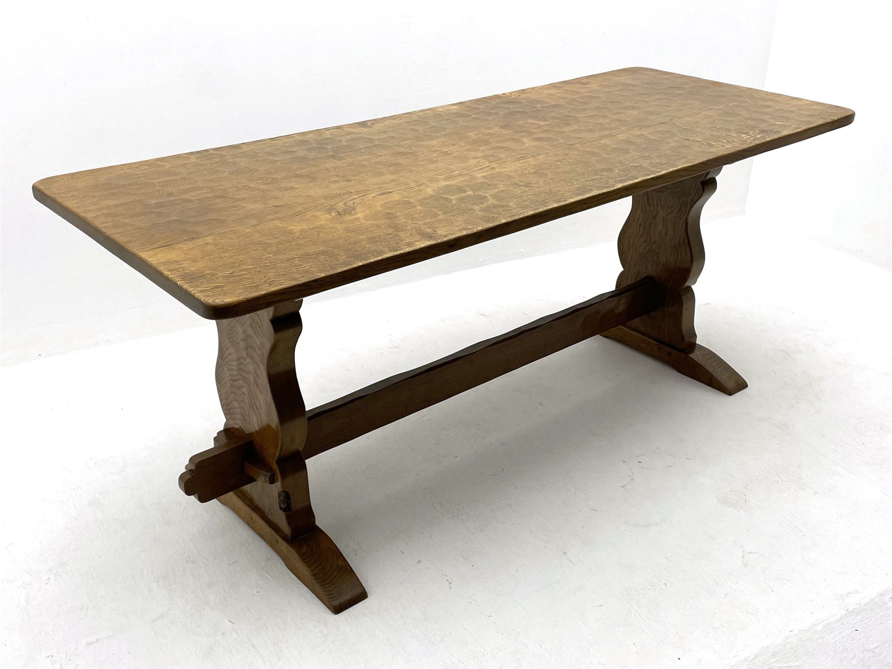 ‘Gnomeman’ oak dining table, rectangular adzed top, shaped end supports on sledge feet joined by pegged stretcher, carved with gnome signature, by Thomas Whittaker of Littlebeck
