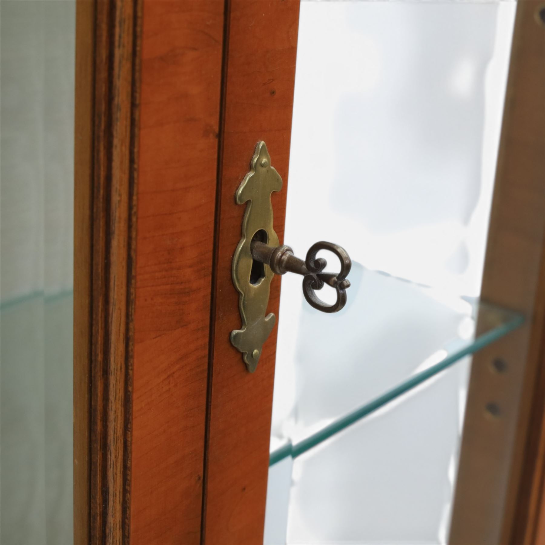 Sheraton design yew wood cabinet on stand, fitted with two glazed doors and two drawers, with lower shelf, illuminated interior