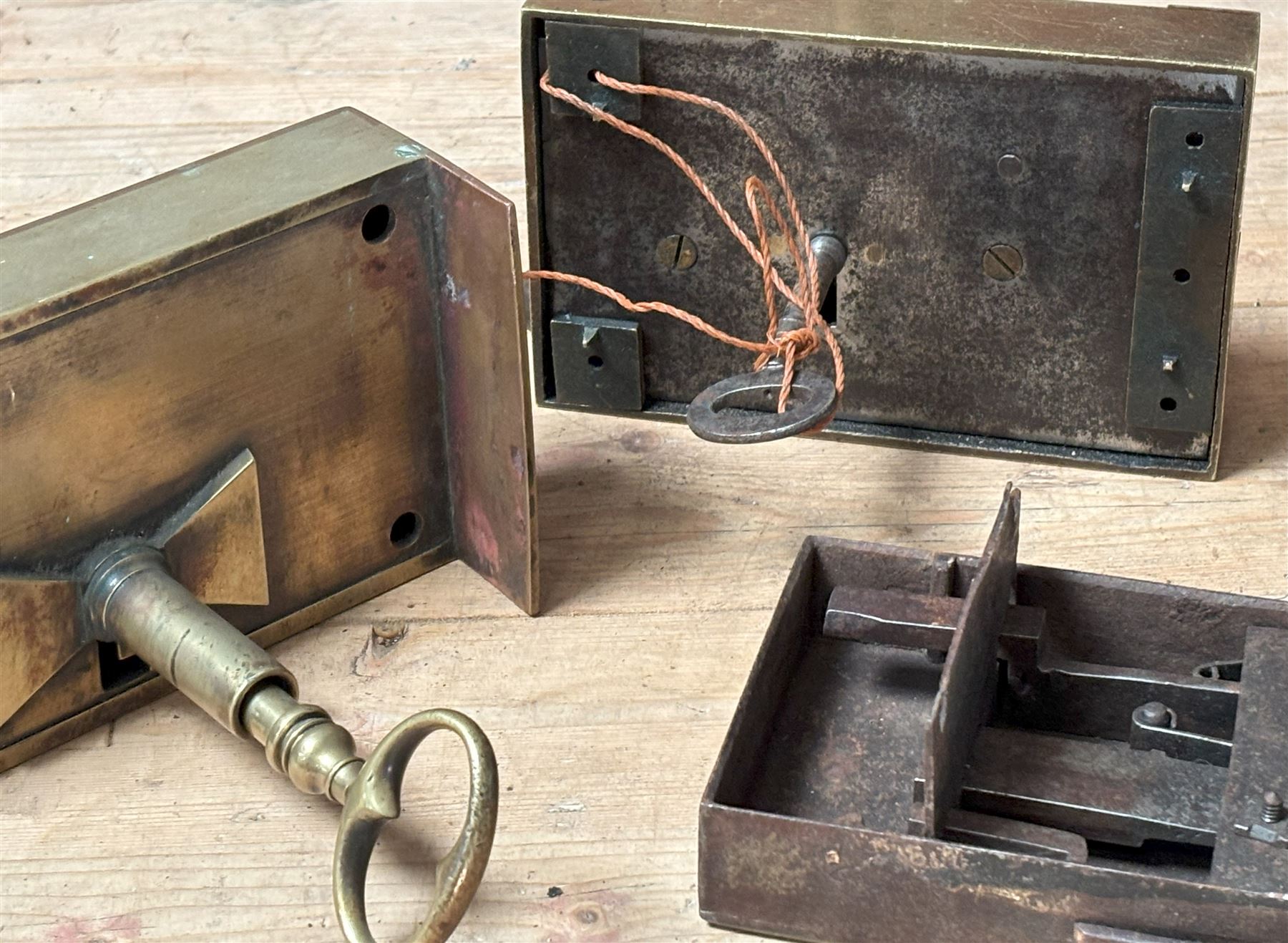 Large 19th century brass dead lock with key (16cm x 11cm) together with a gilt brass cased dead lock, the case with engraved cartouche and filigree, complete with key (18cm x 11cm) together with another engraved brass cased door lock (3)  - COLLECTION BY APPOINTMENT FROM: The White House, Thirsk Road, Easingwold, York, YO61 3NF - CALL 01723 507111 TO ARRANGE