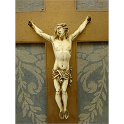  19th century Continental carved ivory Corpus Christi with ivory INRI on a giltwood cross, mounted within giltwood frame, H37cm x W24cm overall  