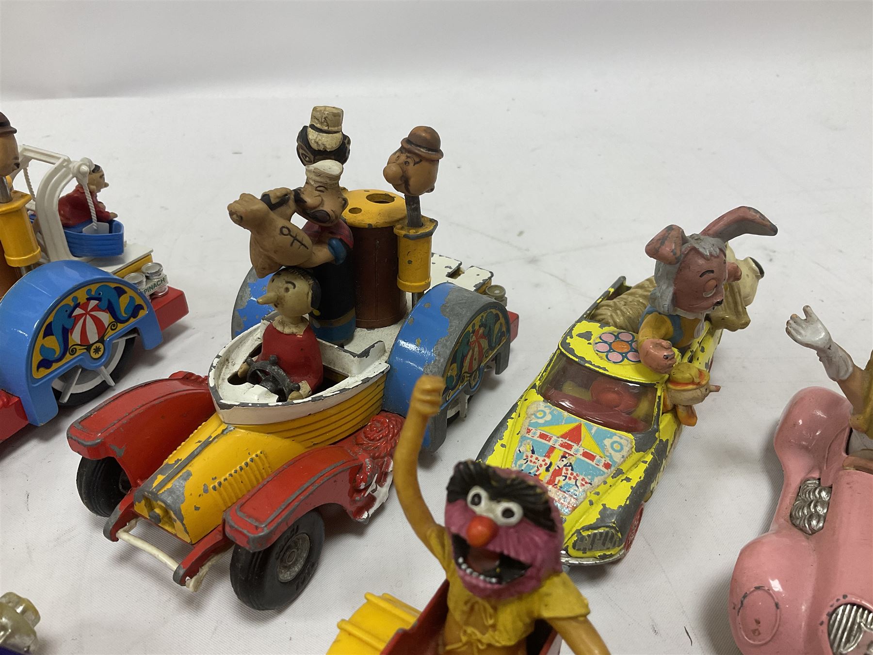 Corgi - ten unboxed and playworn TV/Film related die-cast models including three Popeye Paddle Wagons; Dick Dastardly; Magic Roundabout; Muppets; Batman Penguinmobile; and Basil Brush (10)