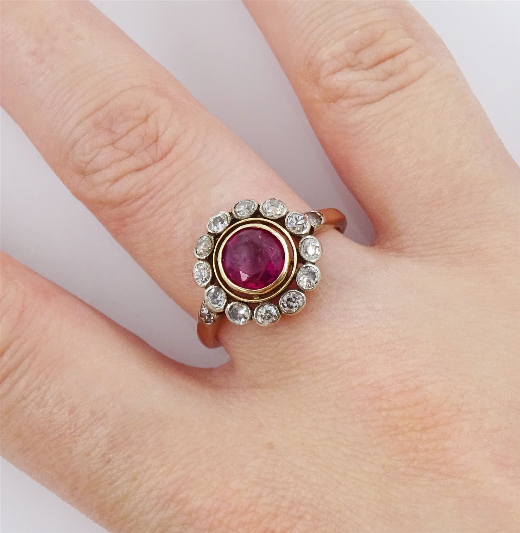 Early 20th century 15ct rose gold round synthetic ruby and milgrain set old cut diamond cluster ring, with diamond set shoulders