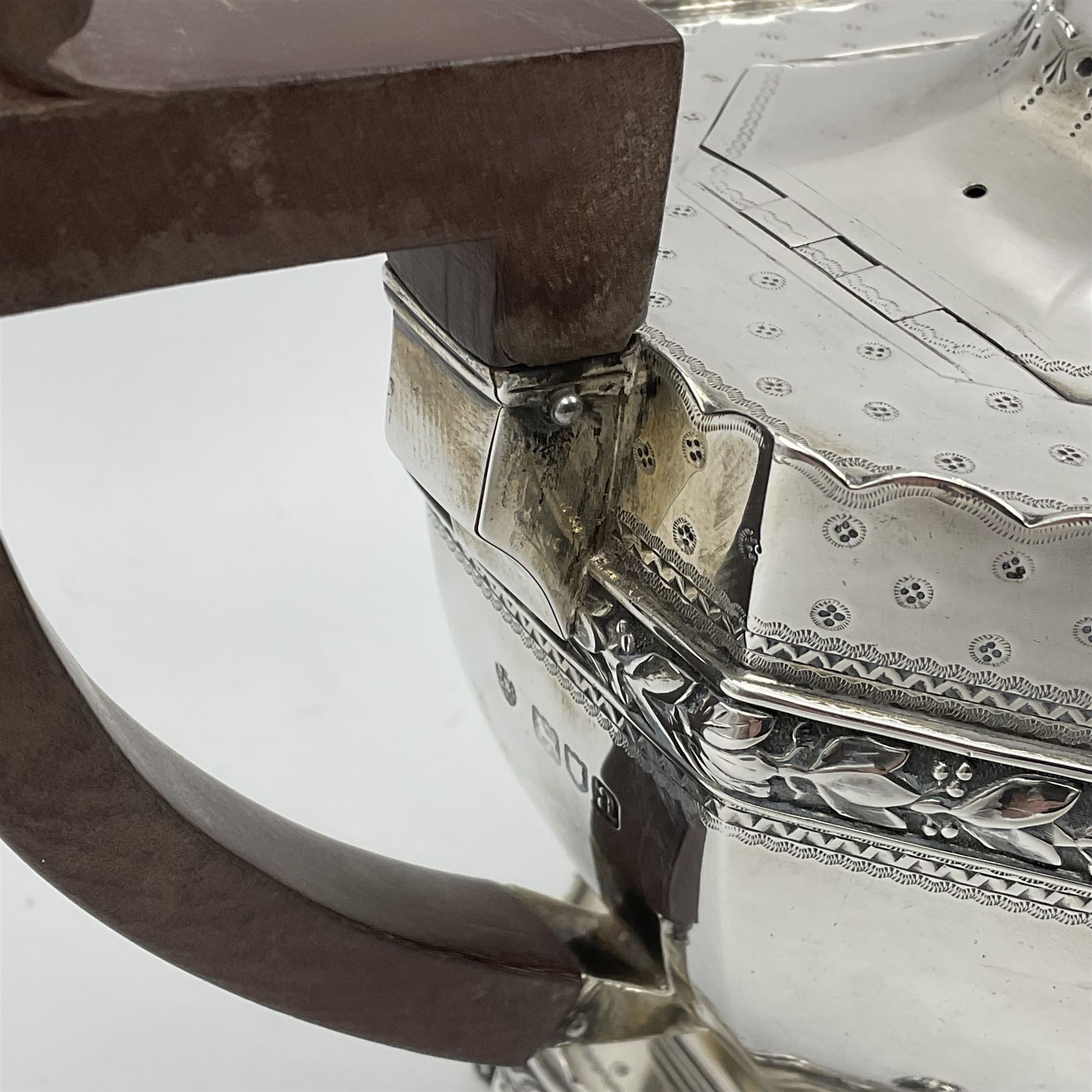 Victorian silver four piece tea service, comprising teapot, teapot stand, twin handled open sucrier and milk jug, each of octagonal form with foliate bud border and engraved decoration including crest to canted panels, and vacant panels, the teapot with ivory finial to the hinged cover and later wooden handle, hallmarked Edward Barnard & Sons Ltd, London1896, teapot including finial H15cm, milk jug including handle H16cm, teapot stand W11.5cm

This item has been registered for sale under Section 10 of the APHA Ivory Act