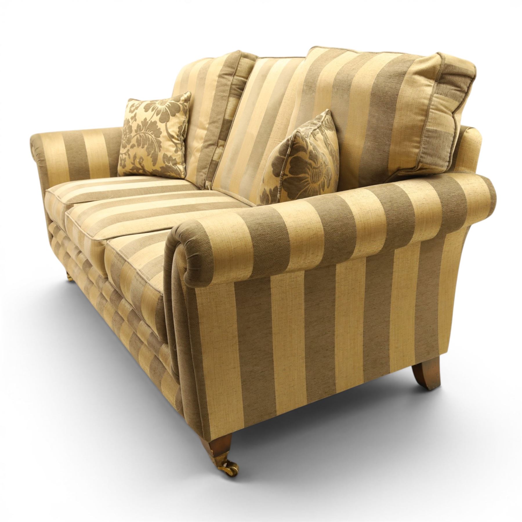 Alstons - 'Ixworth' three seat sofa, upholstered in striped fabric, with loose seat cushions and scrolled arms, front brass castors