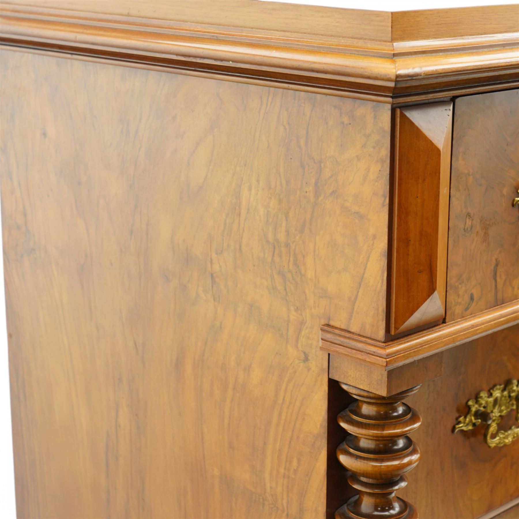 Tall late 19th century walnut chest, stepped and moulded top over six drawers, ornate cast gilt metal handles, enclosed by turned and fluted upright columns, on turned front feet 