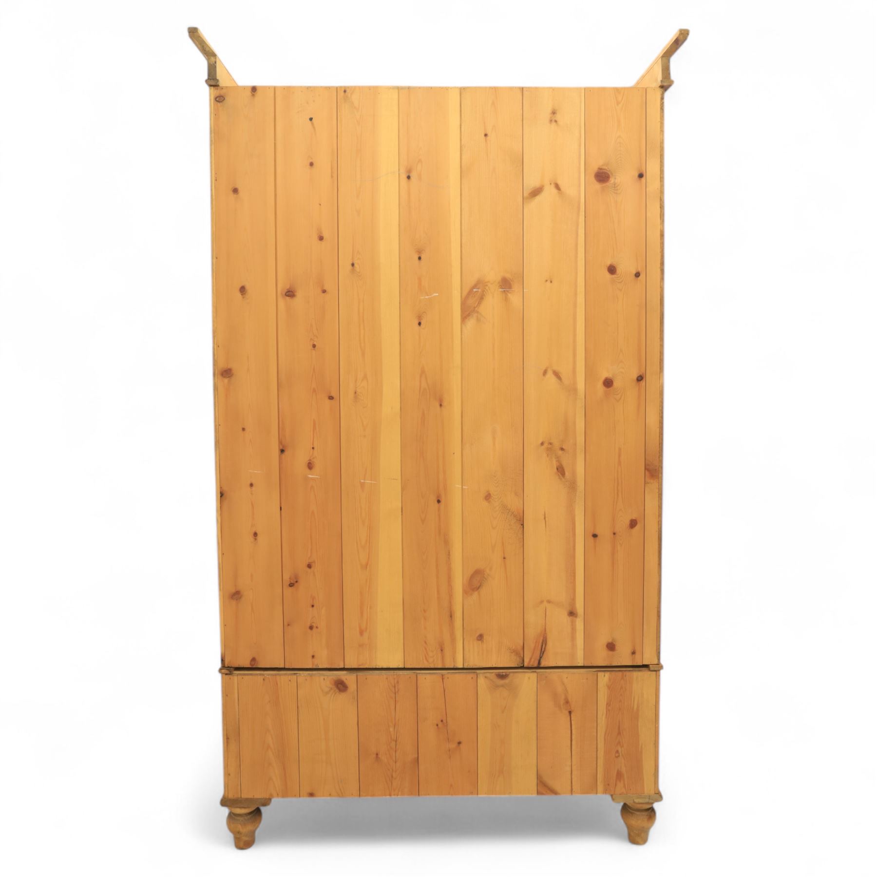 Two contemporary traditional-style wardrobes, projecting plain cornice above two arched moulded panel doors, above a full-width drawer fitted with turned wooden handles, raised on turned bun feet