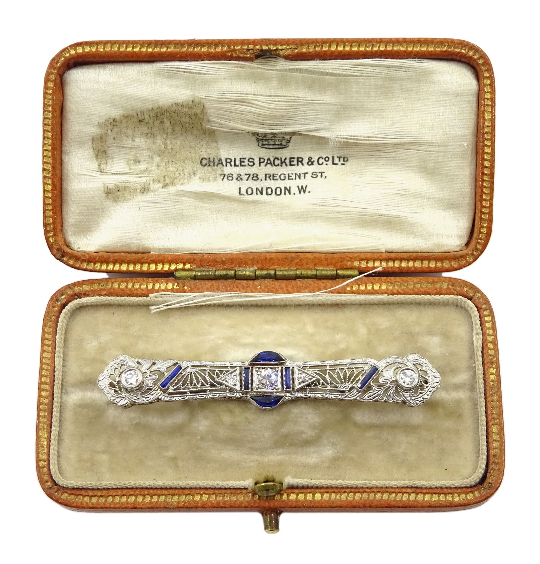 Art Deco platinum diamond and vari-cut synthetic sapphire bar open work brooch, in Charles Packer & Co Ltd, Regents Street, London box