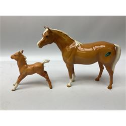 Collection of Beswick horses, including grey horse no.701, palomino foal no 836, grey stocky jogging mare no.855 etc, together two Royal Doulton horses, (8)