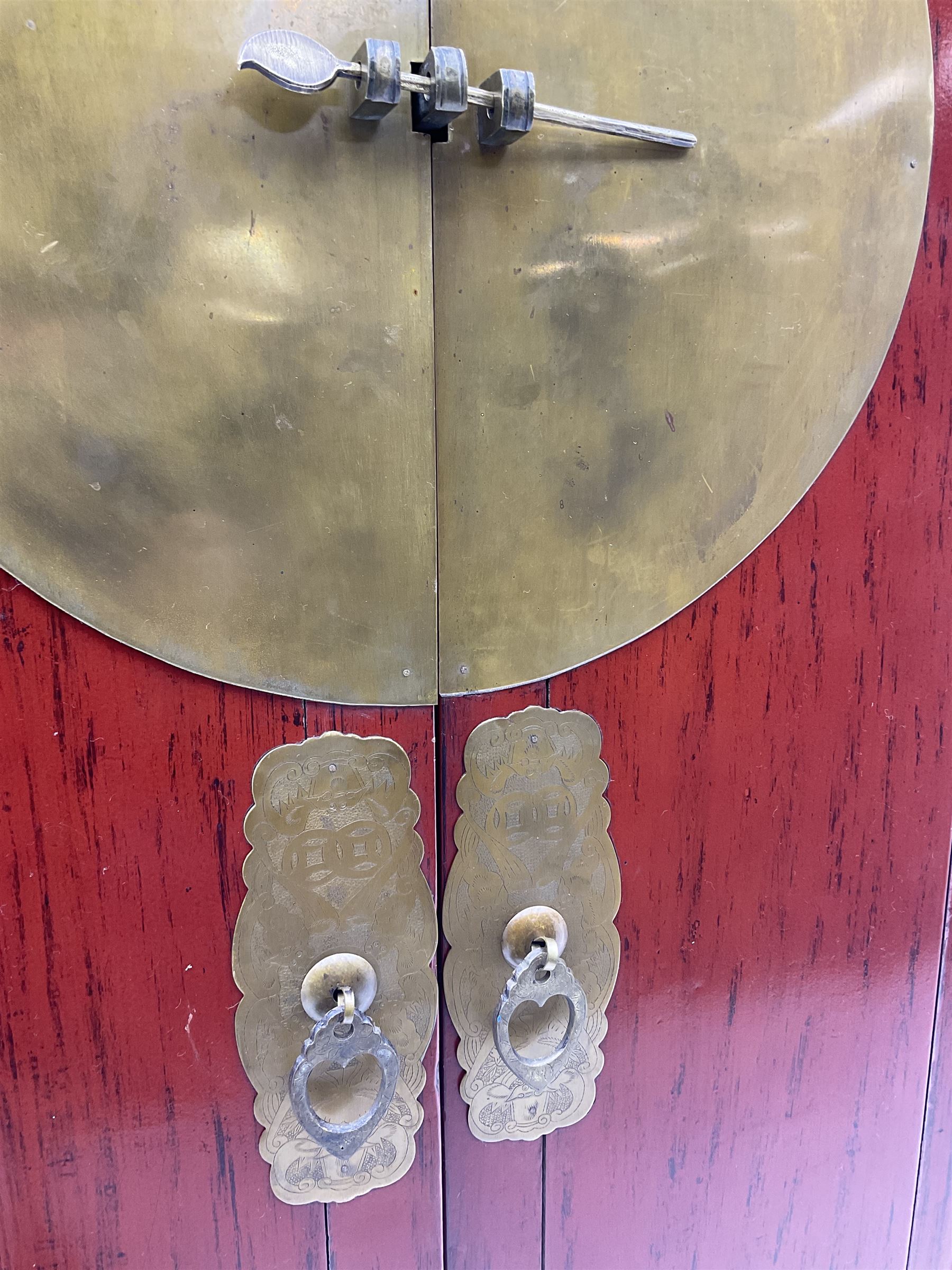  Chinese red lacquered elm and pine Moon marrige cabinet, enclosed by two doors, brass metalwork and hinges