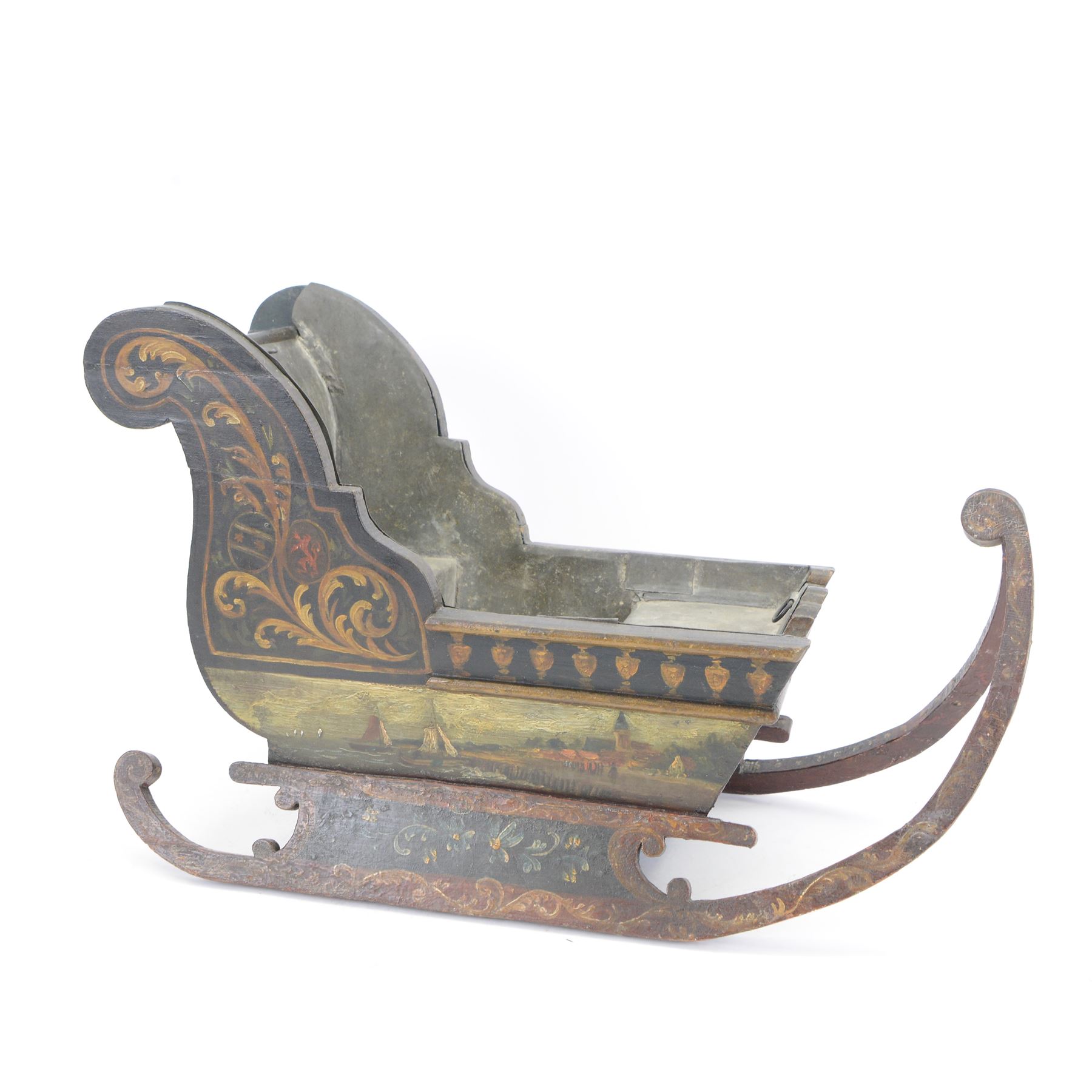Unusual 18th century small Northern European wooden sled, with curved scroll back, the sides painted with coastal shipping scenes, the interior with removable zinc liner, upon curved irons painted with flower heads, H36cm W56cm D29cm