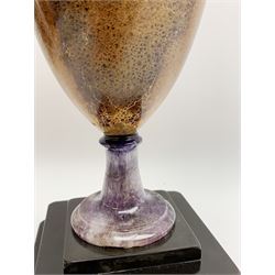 Early 19th century and later Blue John urn, Winnats one vein, of ovoid form with integrated cover and ball finial, upon a spreading circular base, and square stepped black lacquered base, H34.5cm